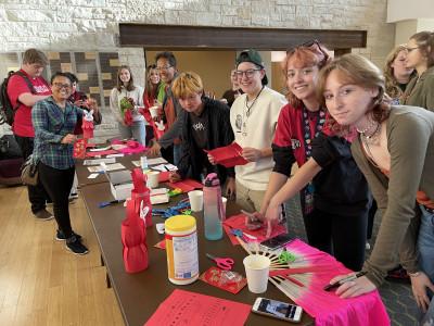 学生, 教师, and community members make paper lanterns to celebrate the Mid-Autumn Festival...